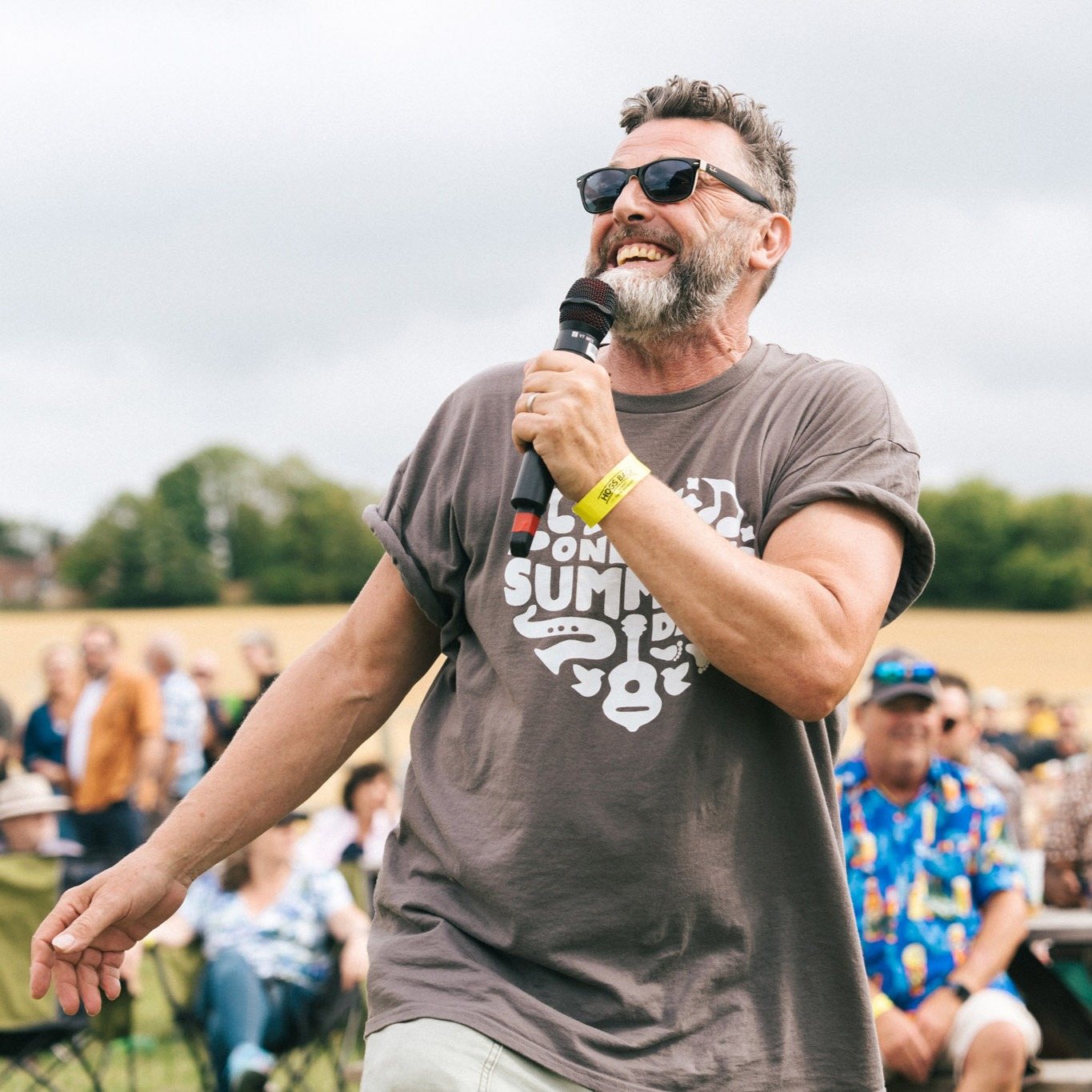 Festival MC with microphone in front of the crowd
