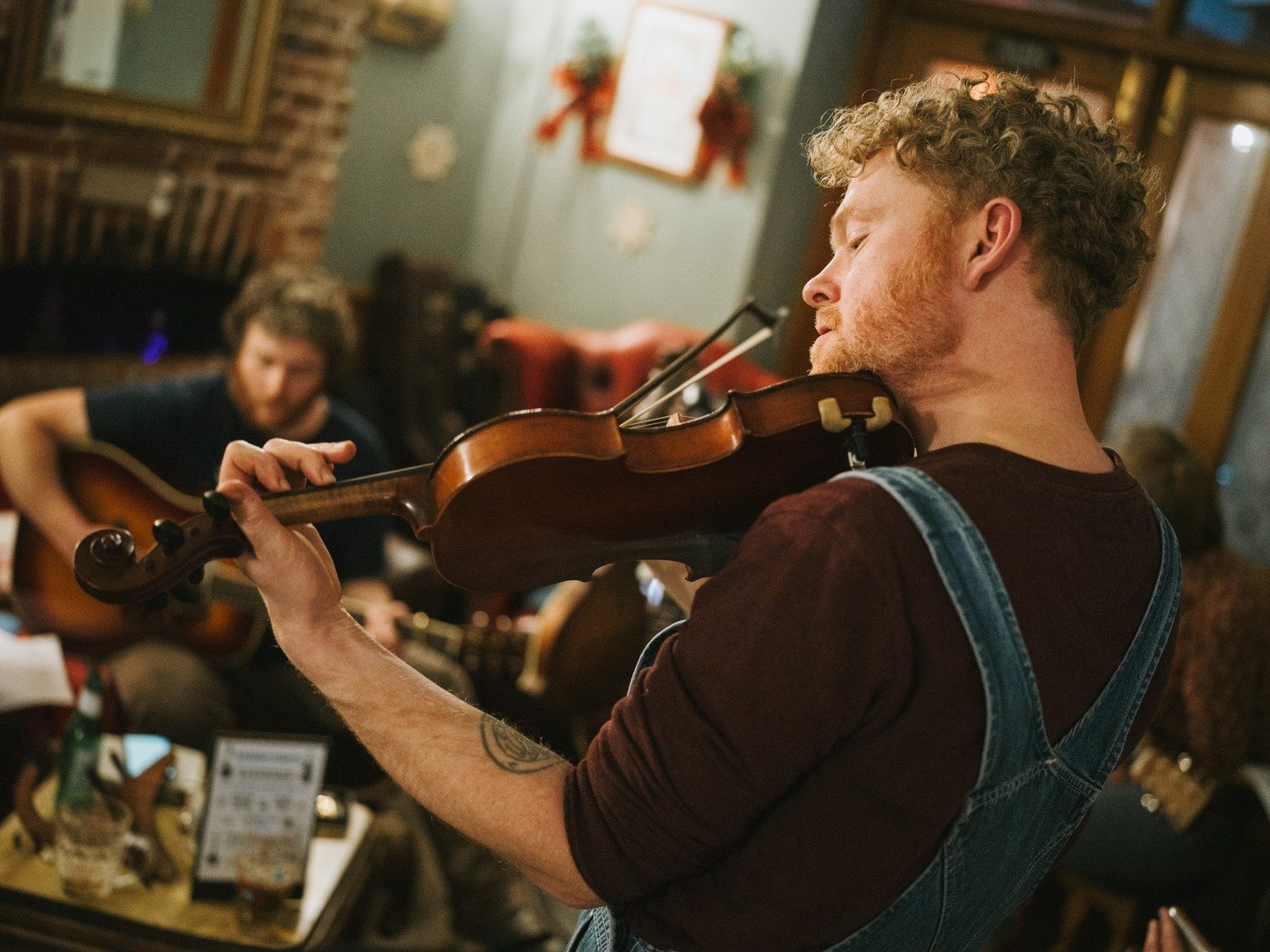 Fiddle player at a pub folk session